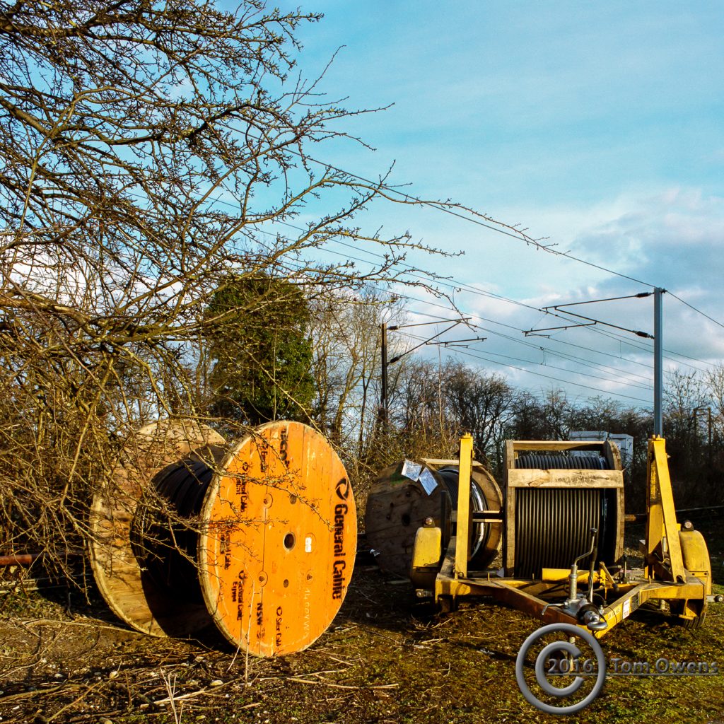 Cable drums alongside railway line in setting sun