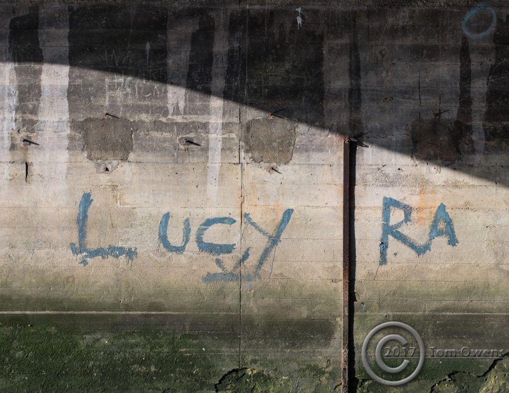Blue paint on concrete spelling Lucy RA