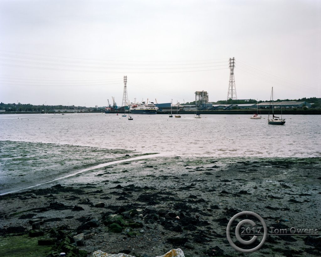 Ship berthed on quay with muddy foreshore