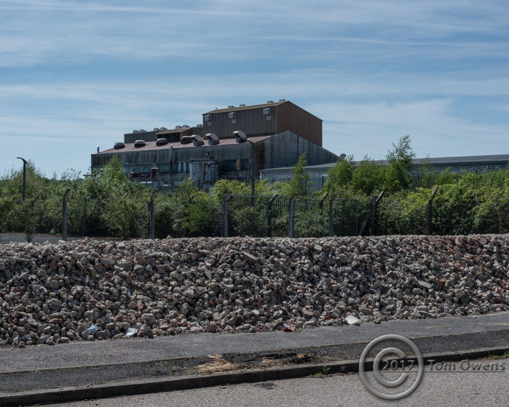 factory building behind rubble bund