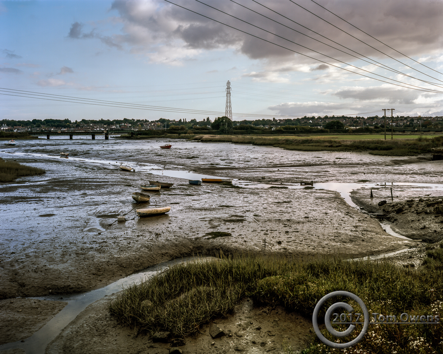 Boats on mud in Cattawade Creek with kingfisher and egret
