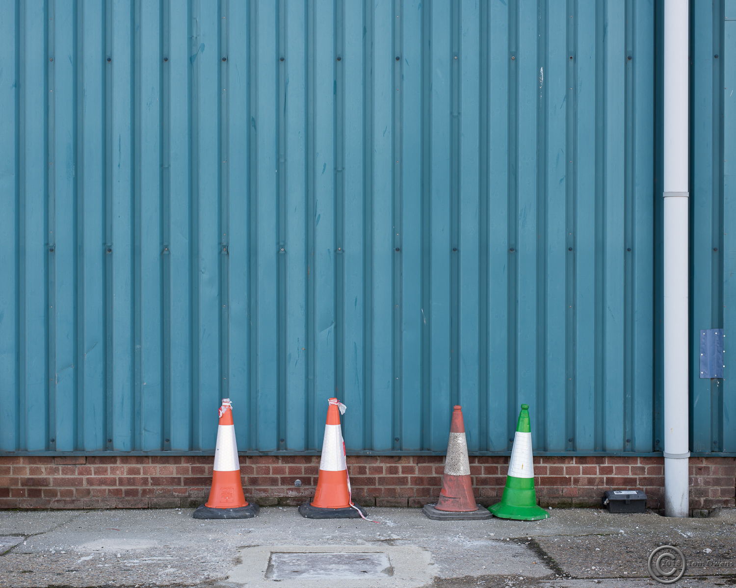 Three red and white, one green and white traffic cones