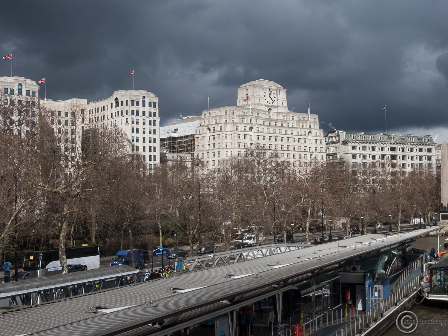 Embankment grey clouds white buildings and union flags