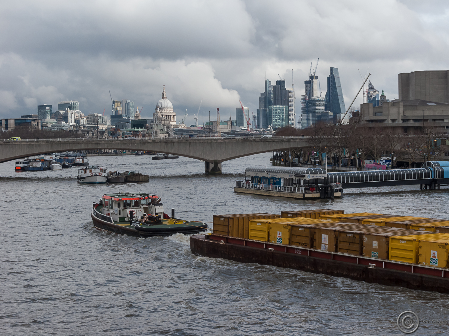Waste barges being towed down the Thames